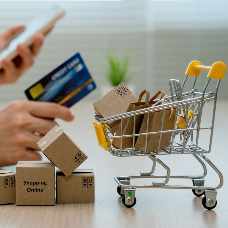 Blogphoto of toycart with shopping bags and creditcard